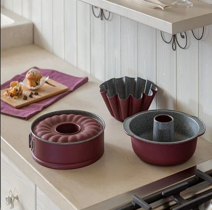Tognana Italian Bakeware UAE collection of premium baking pans and molds on a kitchen counter.