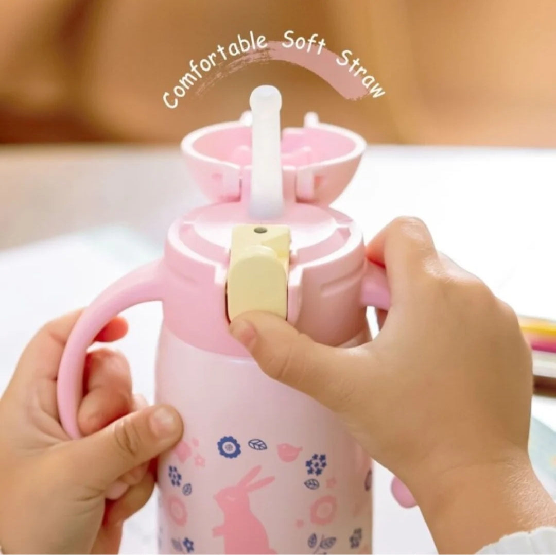 Child holding a pink Zojirushi Kids Bottle featuring a comfortable soft straw, perfect for hydration on the go.