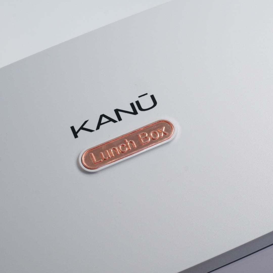 KANßu lunch box with metallic label on a light gray background