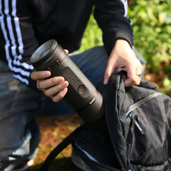 bag packing Outin Fino portable electric coffee grinder in tundra brown finish.