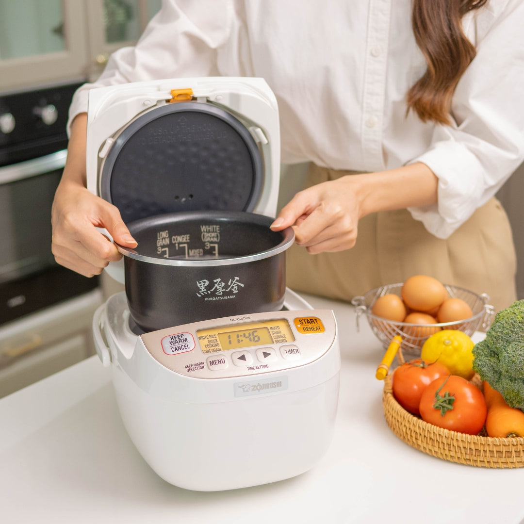 Interior view of Zojirushi NL-BGQ05-WA rice cooker showing non-stick inner pot and cooking capacity
